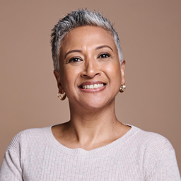 An older woman smiling on a video call